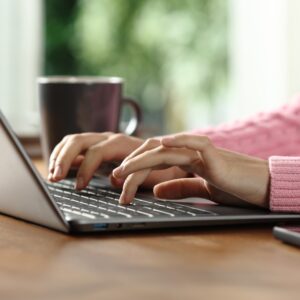 Close,Up,Portrait,Of,A,Woman,Hands,Writing,On,Laptop